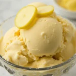 Creamy homemade ginger ice cream in a bowl with fresh ginger slices, served as the perfect dessert.