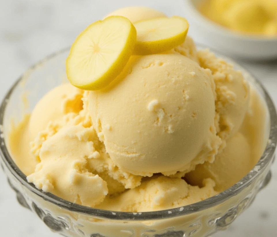 Creamy homemade ginger ice cream in a bowl with fresh ginger slices, served as the perfect dessert.